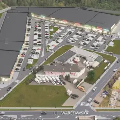 Park handlowy z parkingiem, pokazujący przyczyny upadku dużych galerii handlowych na rzecz mniejszych, dostępnych obiektów.