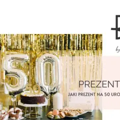 Złote balony z cyfrą 50, tort, ciastka i szampan tworzą atmosferę idealną na elegancki prezent na 50 urodziny dla niej.