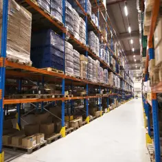 Wielkie regały magazynowe wypełnione towarami. Jak zorganizować logistykę w handlu internetowym: magazyn własny czy FBA?